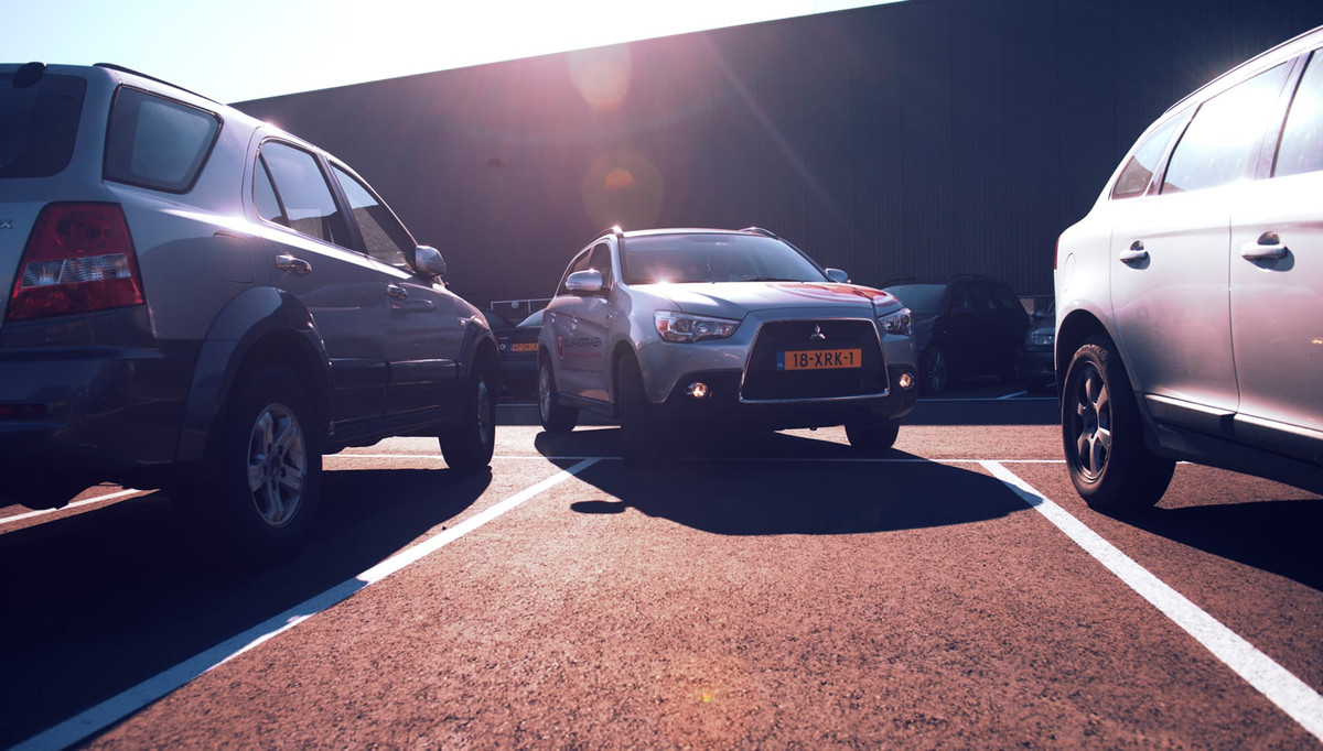 Bil kører ind i en rummelig parkeringsplads på parkeringspladsen hos Easy Airport Parking ved Eindhoven Lufthavn (EIN)