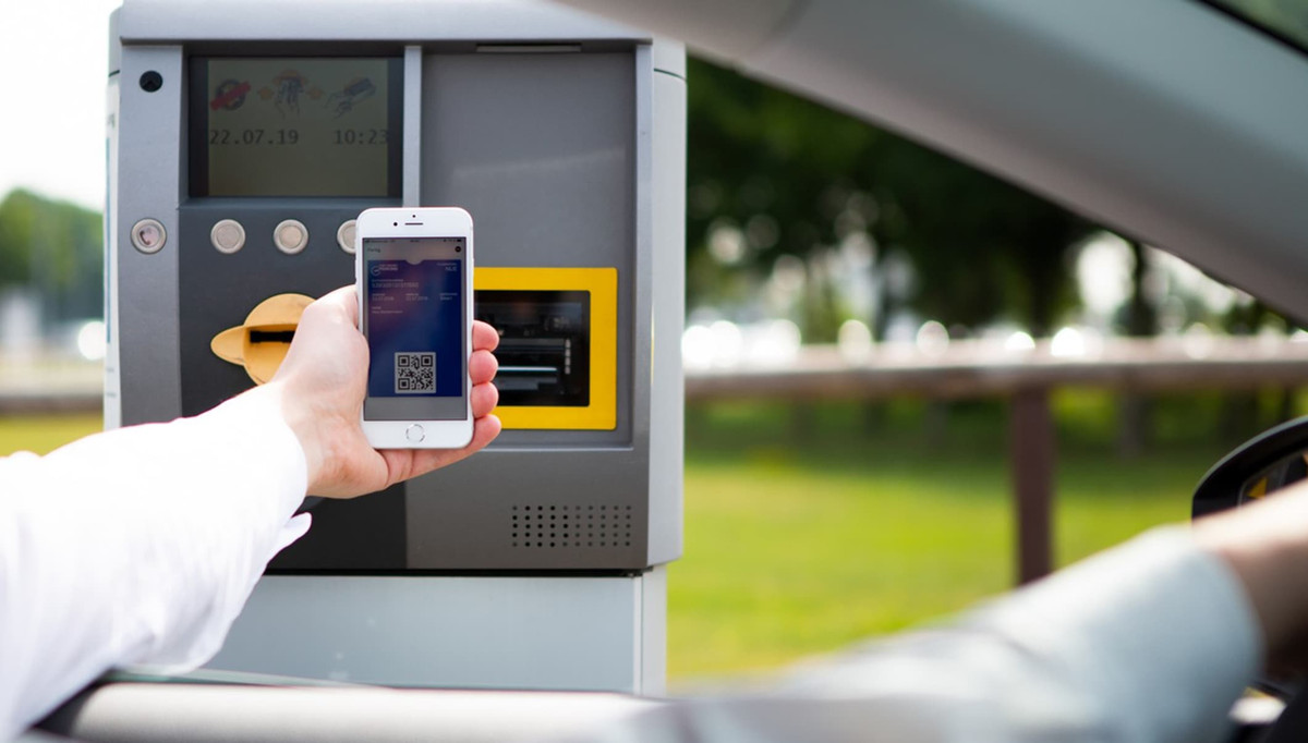 A driver scans a QR code with a smartphone at the entry terminal of the parking lot of Easy Airport Parking at Frankfurt-Hahn Airport (HHN)